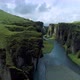 Aerial tracking view of green grassy canyon in Iceland - VideoHive Item for Sale