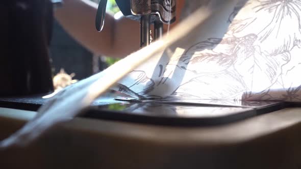 Woman Turn Under And Sew The Edge Of A Cloth Using A Traditional Manual Sewing Machine In Agra City alt