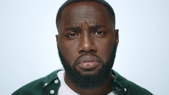 Portrait of Offended African American Man Looking at Camera in Studio alt