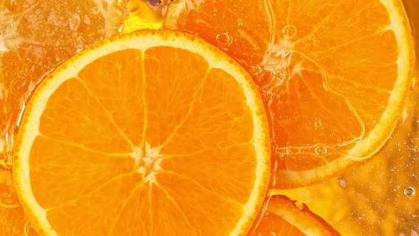 Super Slow Motion Shot of Splashing Fresh Orange Slices Into Water at 1000 Fps alt