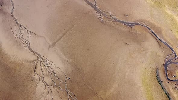 Aerial view: River drying up in sandy desert like environment.