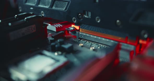 a Man Plug in Video Graphic Card Into the PCI-e on Motherboard alt