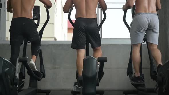 athlete people exercise and training at sport gym, fitness workout with bicycle equipment alt