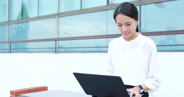 Business woman use of laptop computer at outdoor alt