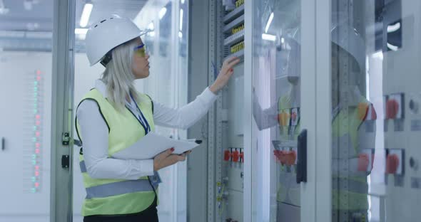 Woman with Tablet Monitoring Electrical Engineering alt