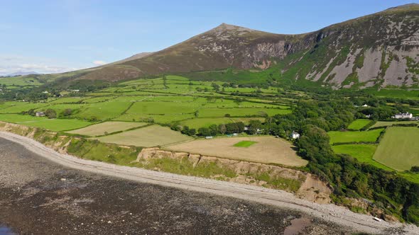 Stunning View Of Lush Fields And Rocky Yr Eifl Mountain At The Coast Of Llyn Peninsula In Wales, UK  alt