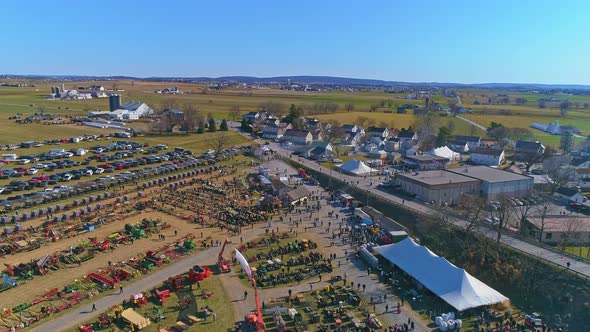 Aerial View of an Amish Mud Sale with Buggies, Farm Equipment and Other Crafts in Early Spring alt