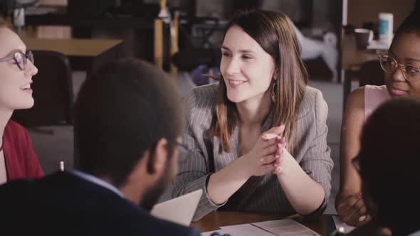 Happy Friendly Businesswoman Listening To Her Colleague at Multiethnic Office Board Meeting alt