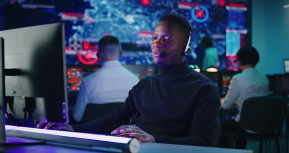 Cheerful African American Man Working in High Tech Security Center alt