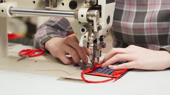Close Up of Female Hands Sewing Trendy Textile Mask alt