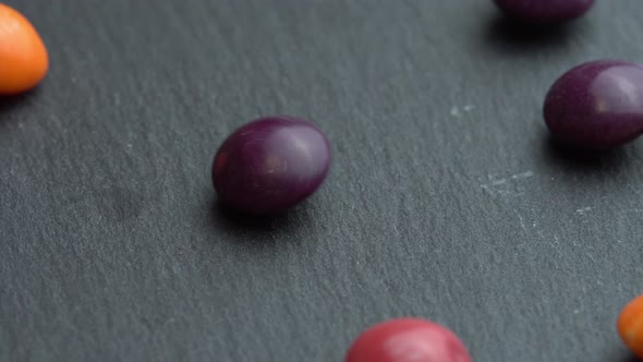 Colored Fruit Sweets Scatter on a Black Background Colored Marco Sweets alt