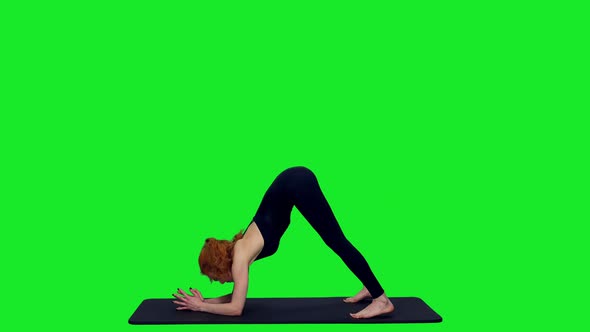Young Slim Sporty Woman Practicing Yoga on Mat against Green Screen