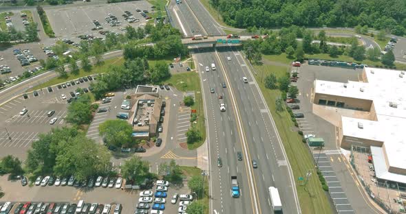 Asphalt Road Going Through Small Typical Settlement and Green Trees on the Horizon Live Aerial View alt