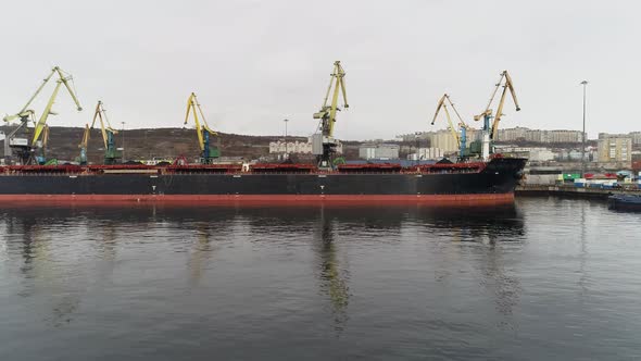 Cargo Vessel with Murmansk City on Background