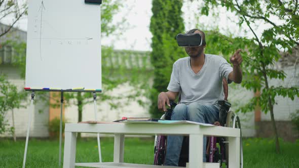 Talented Creative African American Disabled Man in Wheelchair Using VR Headset Designing Project on alt