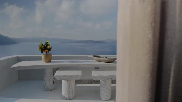 A terrace of a holiday villa overlooking the breathtaking seascape of Santorini. alt