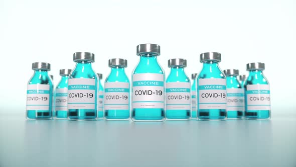 Coronavirus Vaccine in Ampoules Closeup on a Laboratory Table Blue Background alt