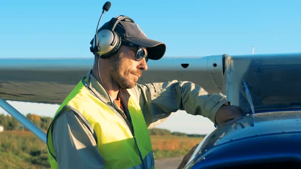 Close Up of Aviation Engineer Inspecting Gas Level in an Airplane alt