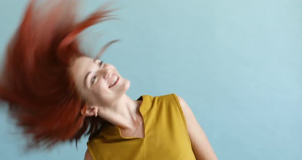 Portrait of a Happy Girl in Studio on a Blue Background