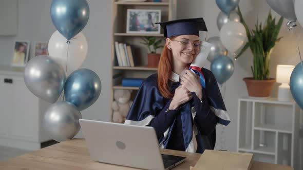 College Graduate Joyful Female Student in Mantle and an Academic Cap is Happy Ending Distance alt