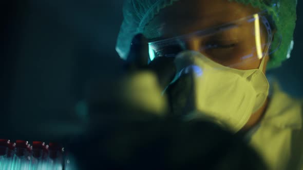 A Woman Scientist is Looking Into Microscope Biochemical Research alt