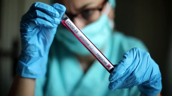 Doctor hands holding a coronavirus COVID-19 negative test tube