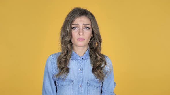 Surprised Young Girl in Shock Isolated on Yellow Background Wondering alt