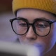Portrait of a Young Caucasian Woman Trader in Hat Wearing Eyeglasses Looking at a Computer Screen - VideoHive Item for Sale
