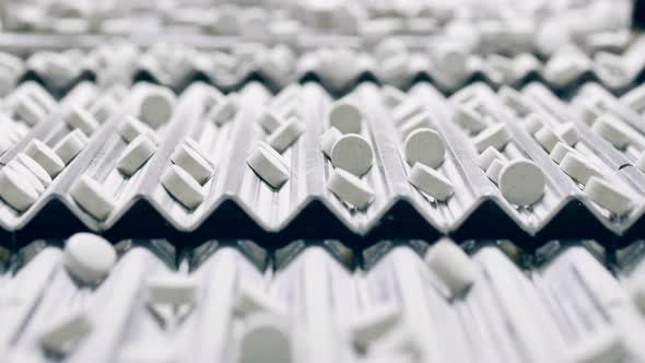 Tablets are Getting Mechanically Transported By a Conveyor alt