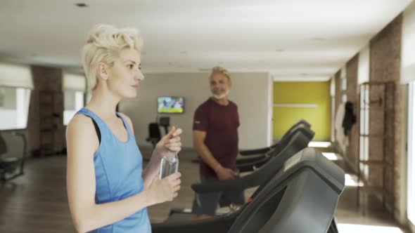 Man and woman exercising in gym