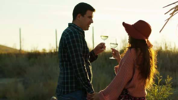 Couple Holding Hands and Tasting White Wine alt