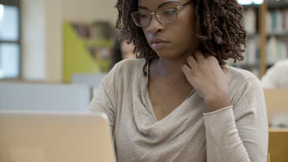 Pensive African American Student Using Laptop alt