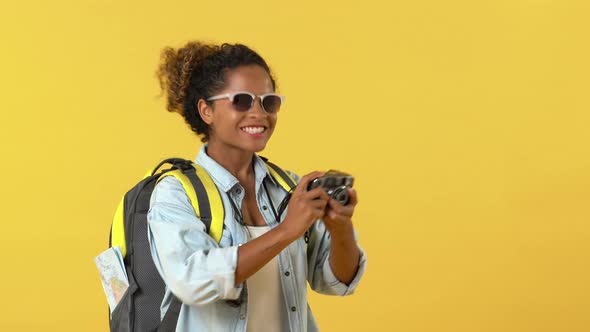 African American woman tourist backpacker taking photo
