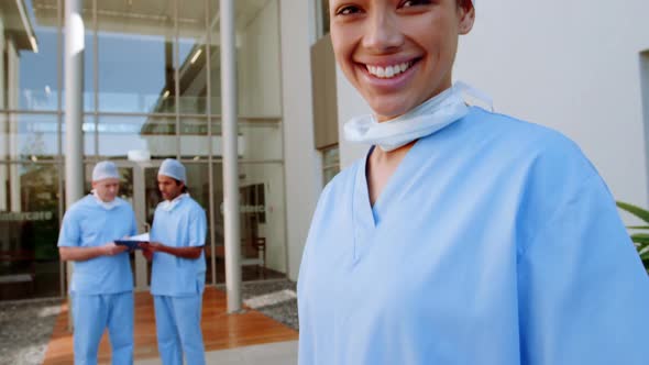 Portrait of a mixed race female surgeon working in a hospital, wearing face mask for hygiene against alt