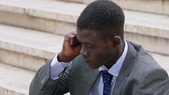 worried and sad young black African businessman. bankruptcy, dismissal alt