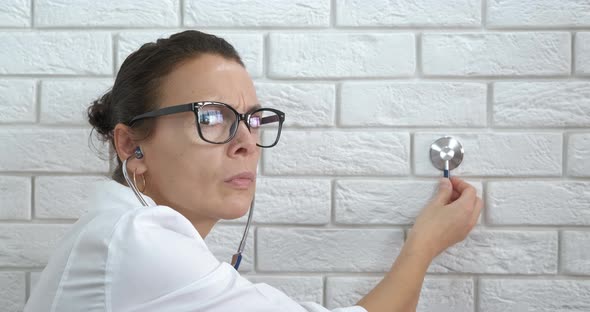 Doctor with Stethoscope in Ears alt