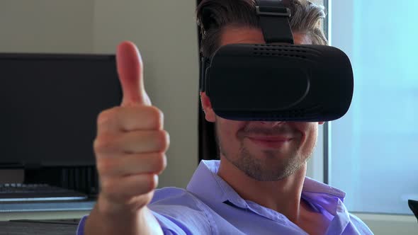 Young Handsome Man Uses Virtual Reality Glasses and Shows Thumb Up To the Camera in Living Room alt