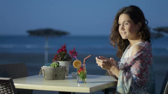 Happy Beautiful Woman Chatting Online on Smartphone, Vacation at Seaside alt