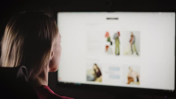 A Woman is Looking for Clothes in Online Stores alt