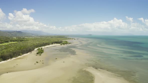 Aerial, Low Tide And Huge Sand Ocean Bed And Mangroves Growing In Queensland Australia