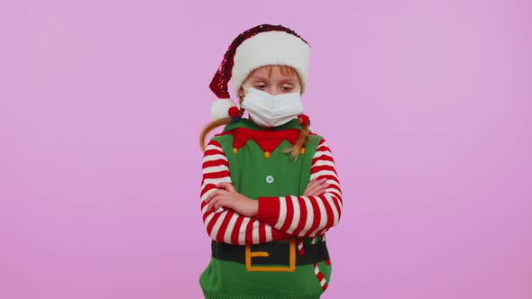 Girl Christmas Santa Claus Elf in Face Mask PPE to Safe From Coronavirus on Lockdown Quarantine alt