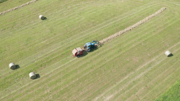 Blue Tractor Hay Bales Aerial View alt