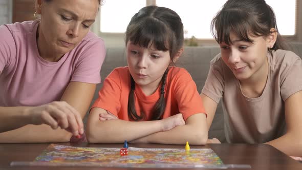 Family playing table game.  alt