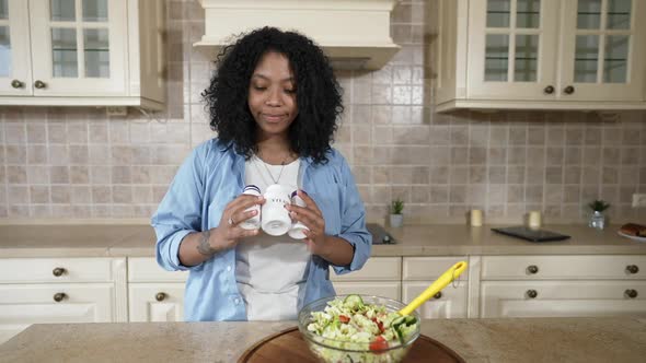 Front View Positive African American Woman Posing with Vitamins Standing in Kitchen with Healthful alt