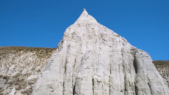 A cone shaped hill. High limestone pillar, chalk mountain