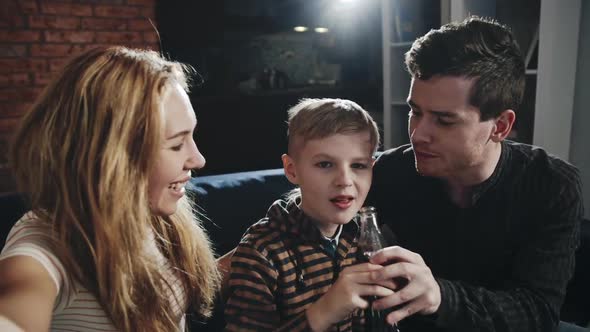 Happy Parents and Their Teenager Son Taking Photos for Family Album. Concept of Memories. Modern alt