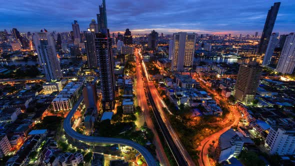 Bangkok business district city center above trident road, night to day, zoom out - Time Lapse