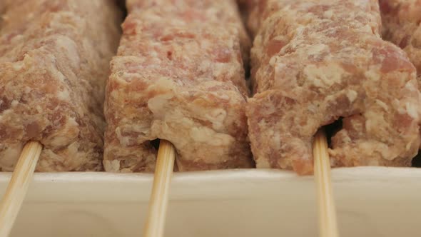Close-up View Of Uncook Mititei On Skewers - Romanian Cuisine. - slider alt