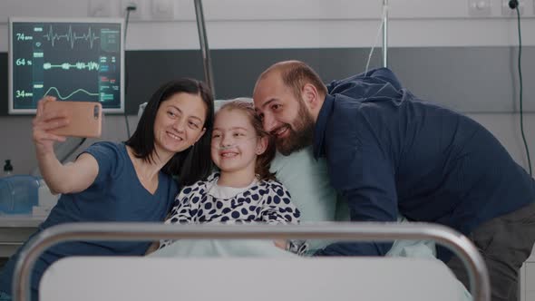 Positivity Family Taking Selfie Using Modern Smartphone During Disease Consultation alt