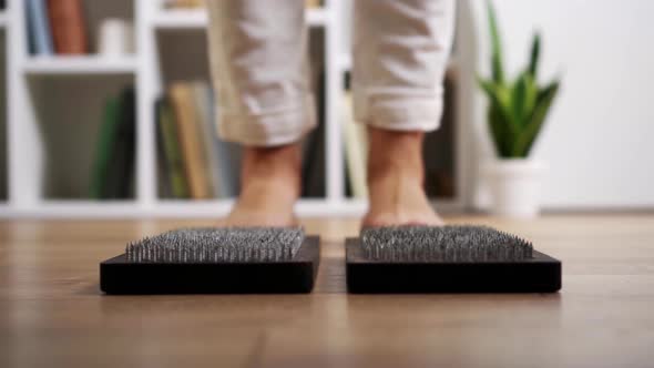 A Board With Nails Ready For The Practice Of Standing On Nails On The Floor. Close Woman Practicing alt